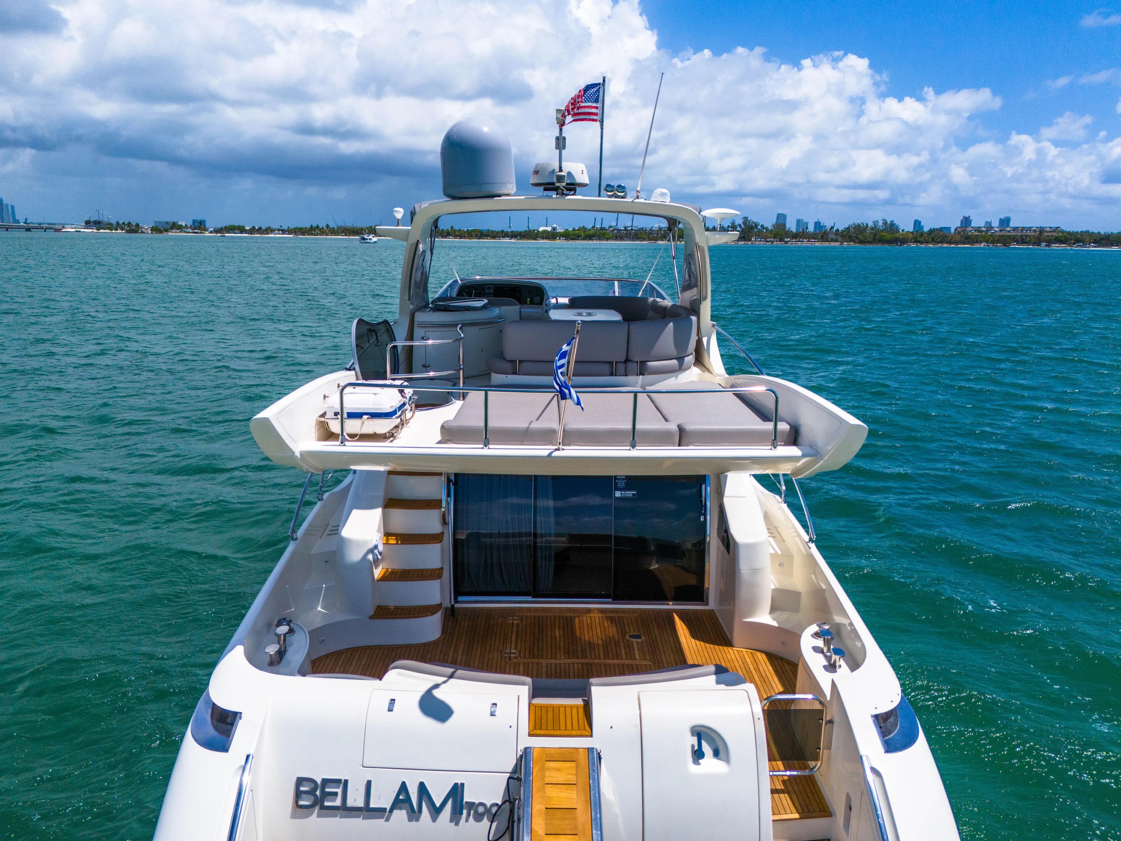 Bellami Too Yacht Photos Pics 2008 Azimut 62E yacht on water, rear view, sunny day, American flag flying.