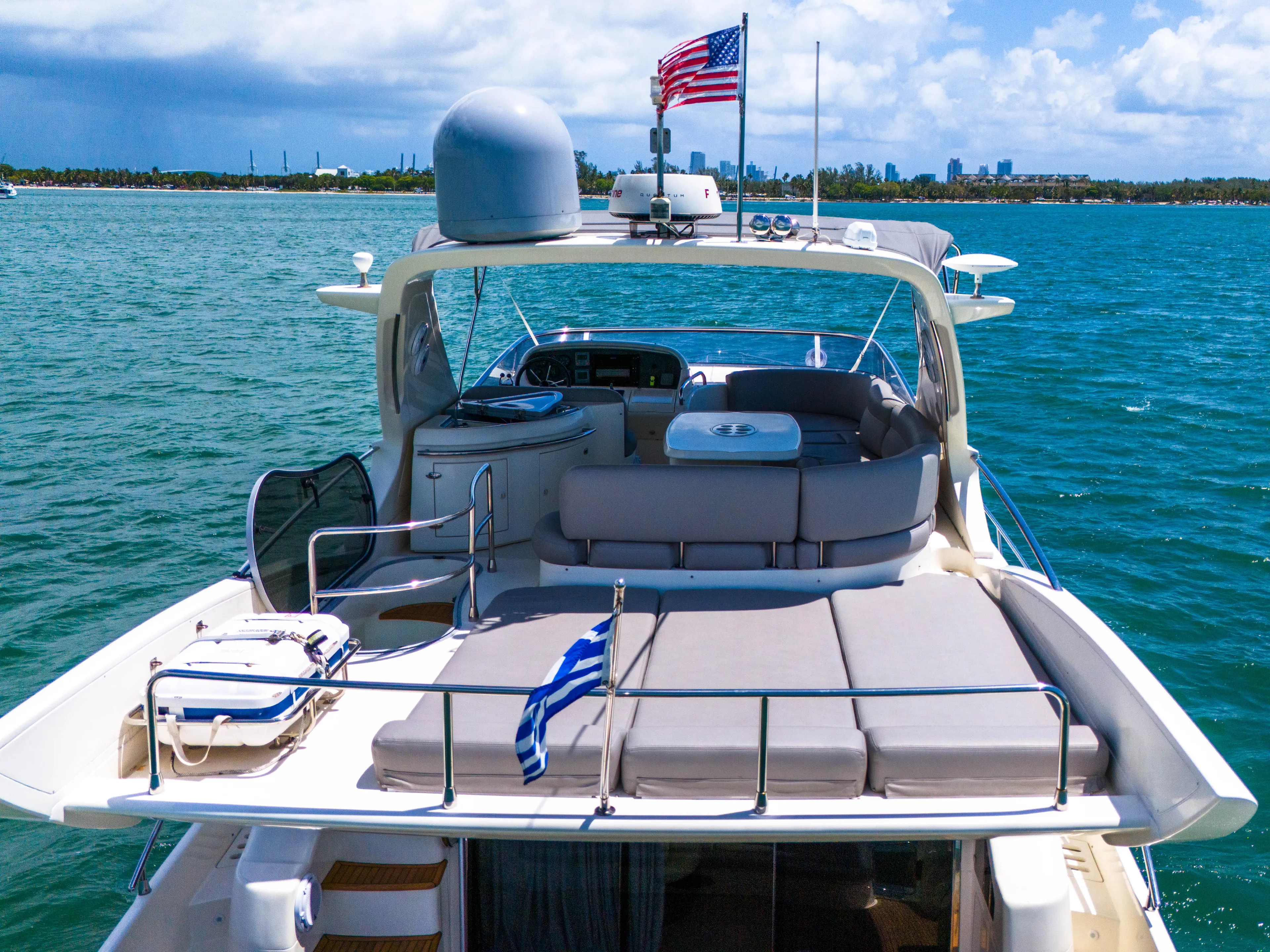 Bellami Too Yacht Photos Pics 2008 Azimut 62E yacht on water, featuring spacious deck and American flag.