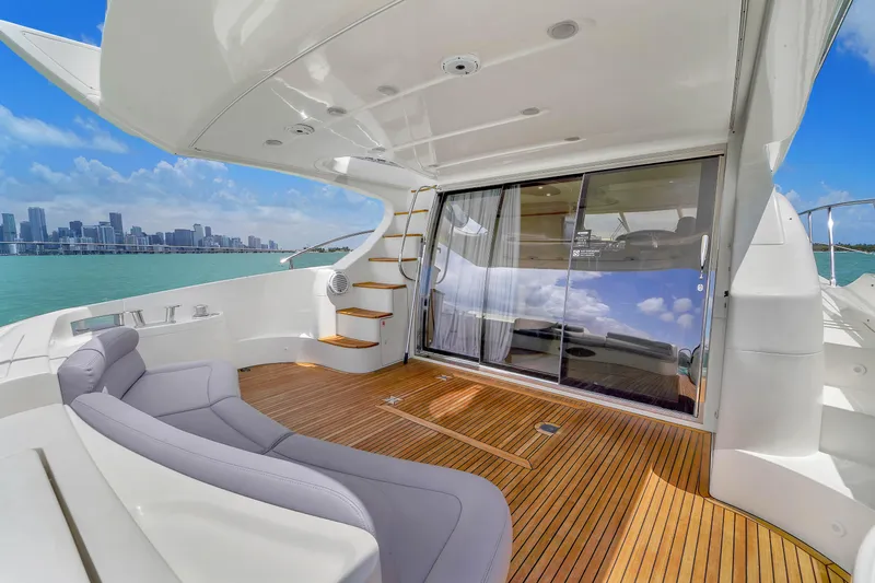 Bellami Too Yacht Photos Pics 2008 Azimut 62E yacht deck with sleek seating, wooden flooring, and ocean view.