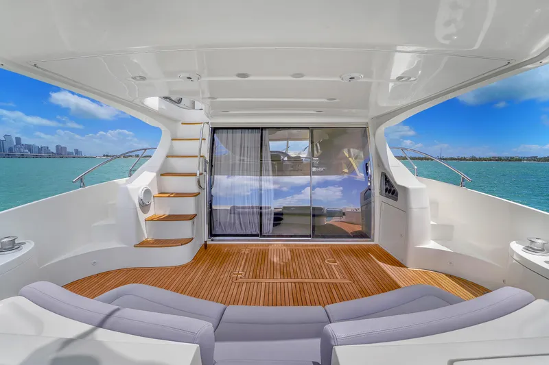 Bellami Too Yacht Photos Pics Luxurious 2008 Azimut 62E yacht interior with wooden deck and ocean view.