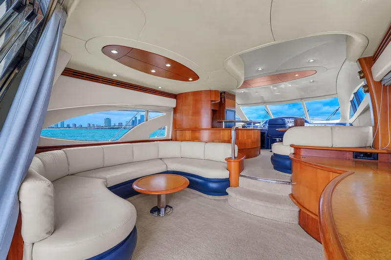 Bellami Too Yacht Photos Pics Luxurious interior of a 2008 Azimut 62E yacht with elegant seating and panoramic windows.