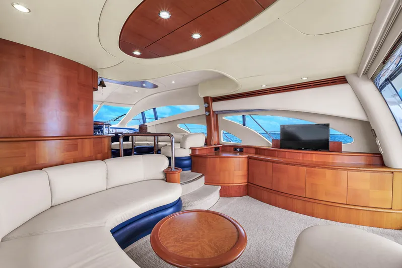 Bellami Too Yacht Photos Pics Luxurious interior of a 2008 Azimut 62E yacht with elegant wood finishes and modern seating.