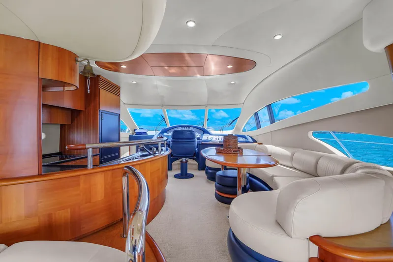 Bellami Too Yacht Photos Pics Luxurious interior of a 2008 Azimut 62E yacht with elegant seating and panoramic windows.
