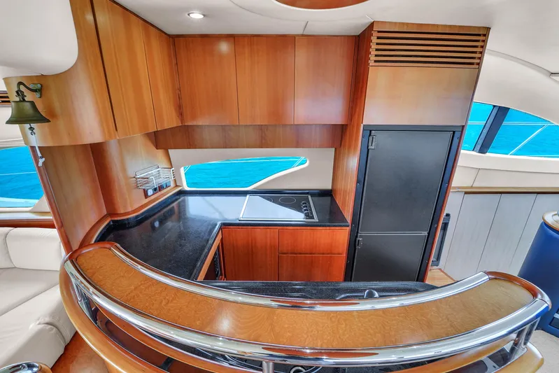 Bellami Too Yacht Photos Pics Luxurious 2008 Azimut 62E yacht interior with sleek wooden cabinetry and modern kitchen amenities.