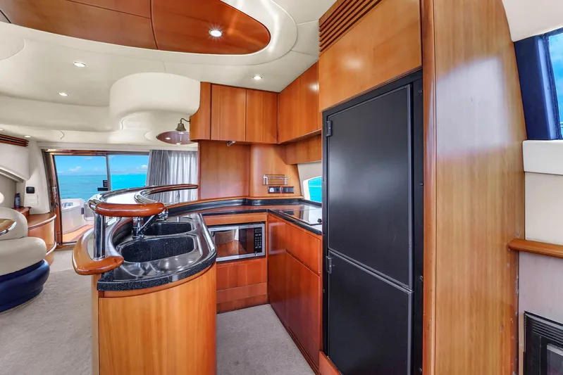 Bellami Too Yacht Photos Pics Luxurious 2008 Azimut 62E yacht interior with modern kitchen and ocean view.