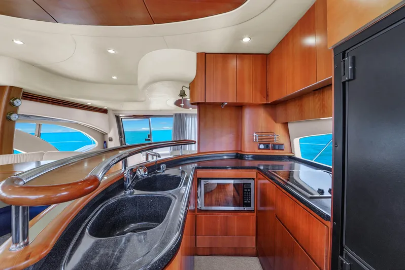 Bellami Too Yacht Photos Pics Luxurious kitchen interior of 2008 Azimut 62E yacht with modern amenities and ocean view.