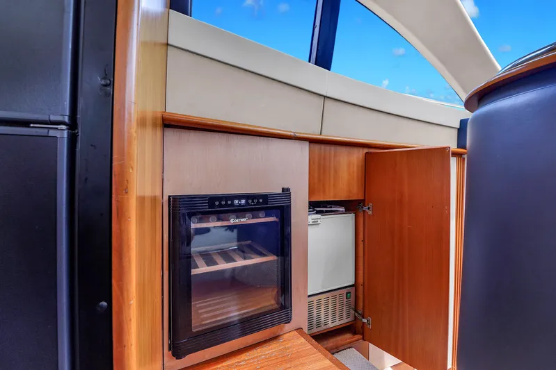 Bellami Too Yacht Photos Pics 2008 Azimut 62E yacht interior with wooden cabinetry and built-in appliances.