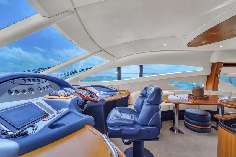 Bellami Too Yacht Photos Pics Luxurious interior of 2008 Azimut 62E yacht with modern helm and seating.