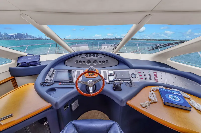 Bellami Too Yacht Photos Pics Helm of 2008 Azimut 62E yacht with ocean view and navigation equipment.