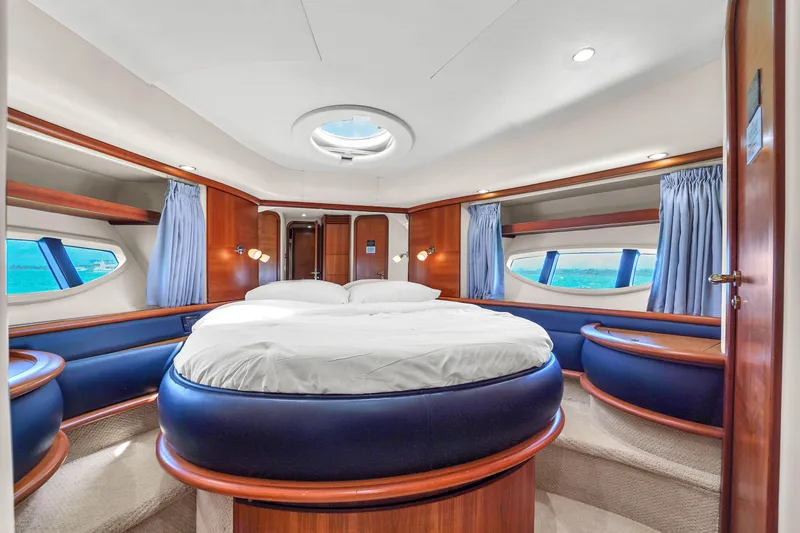 Bellami Too Yacht Photos Pics Luxurious interior of 2008 Azimut 62E yacht with circular bed and elegant wood finishes.