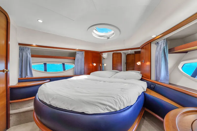 Bellami Too Yacht Photos Pics Luxurious bedroom interior of 2008 Azimut 62E yacht with round bed and ocean view.