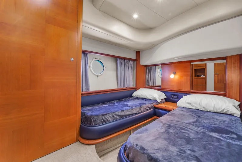 Bellami Too Yacht Photos Pics Luxurious cabin interior of 2008 Azimut 62E yacht with twin beds and wooden finishes.