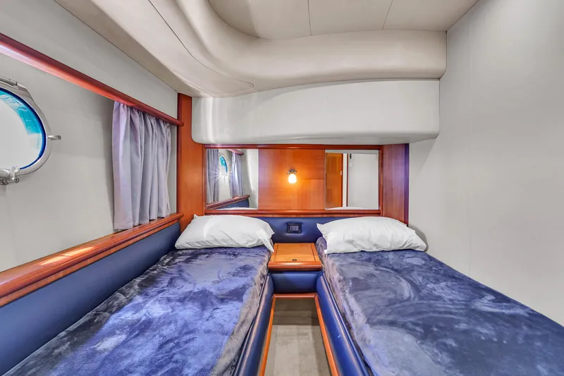 Bellami Too Yacht Photos Pics Luxurious twin cabin interior of 2008 Azimut 62E yacht with plush bedding and porthole.