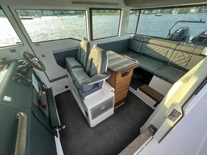 Tiny Dancer Yacht Photos Pics Interior of 2020 Axopar 37 XC boat with seating and helm, overlooking water.