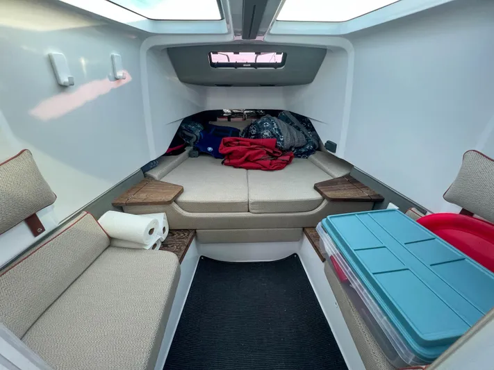 Tiny Dancer Yacht Photos Pics 2020 Axopar 37 XC cabin interior with seating, storage, and natural light.