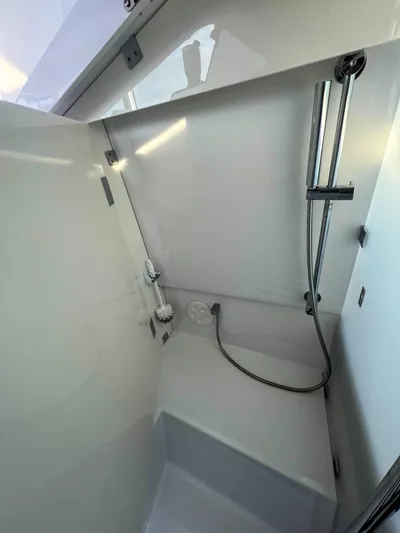 Tiny Dancer Yacht Photos Pics 2020 Axopar 37 XC boat shower area with modern fixtures and sleek design.