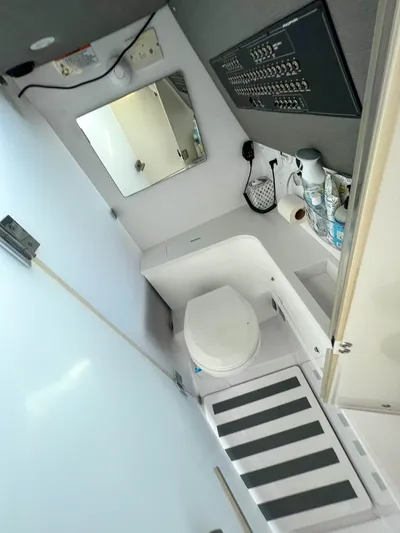 Tiny Dancer Yacht Photos Pics 2020 Axopar 37 XC boat bathroom with toilet, mirror, and control panel.
