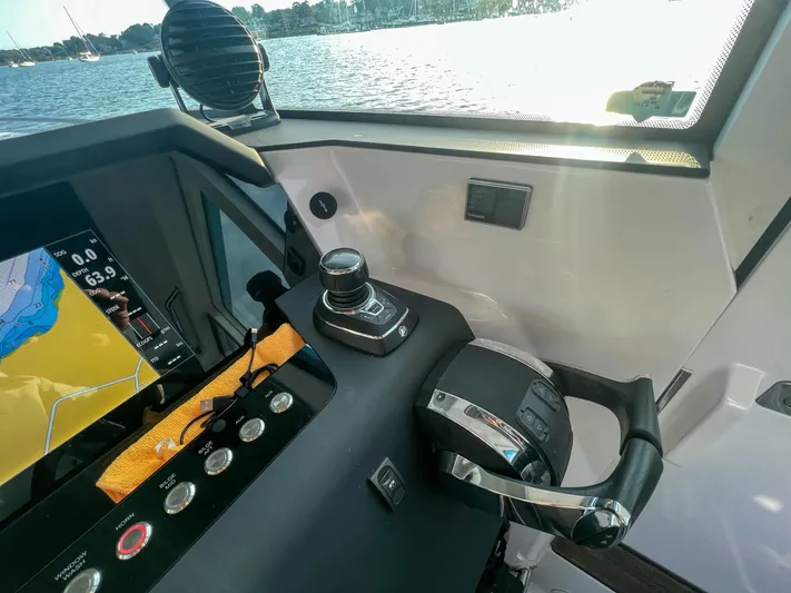 Tiny Dancer Yacht Photos Pics Control panel of 2020 Axopar 37 XC boat with navigation screen and throttle lever.