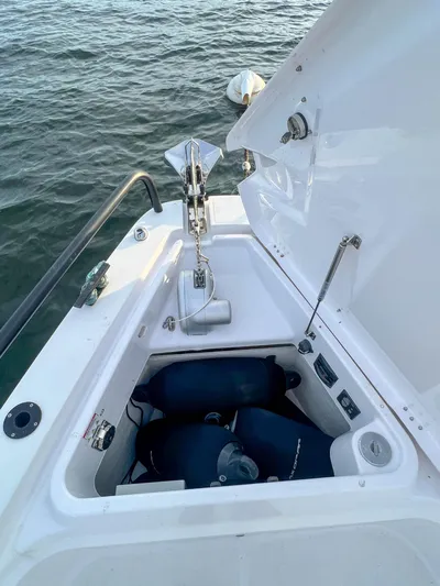 Tiny Dancer Yacht Photos Pics 2020 Axopar 37 XC boat anchor compartment with open hatch, docked on water.