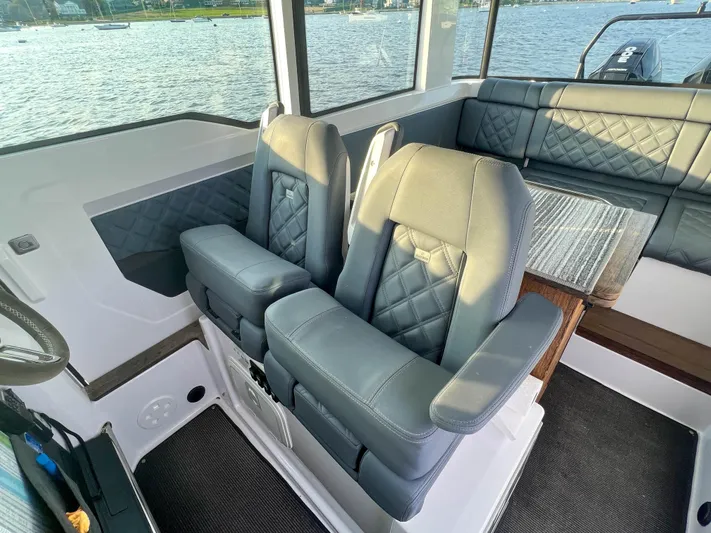 Tiny Dancer Yacht Photos Pics 2020 Axopar 37 XC interior with luxurious seating and waterfront view.