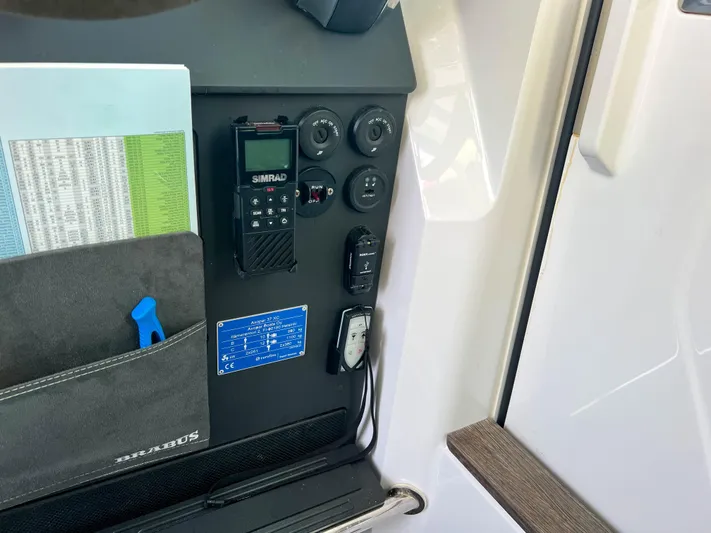 Tiny Dancer Yacht Photos Pics Control panel of 2020 Axopar 37 XC boat with Simrad radio and storage pocket.