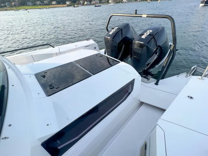 Tiny Dancer Yacht Photos Pics 2020 Axopar 37 XC boat with twin outboard engines on a calm water backdrop.