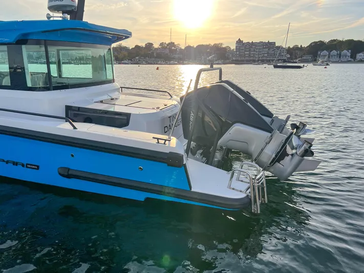 Tiny Dancer Yacht Photos Pics 2020 Axopar 37 XC boat on water at sunset, featuring sleek design and powerful outboard motor.