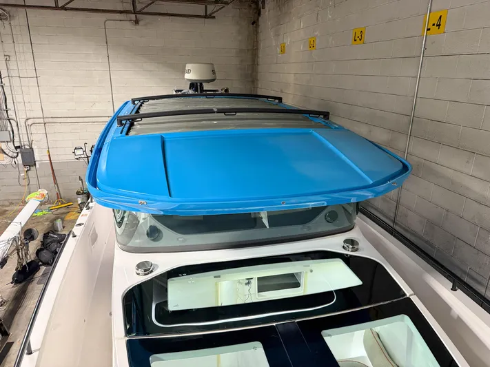 Tiny Dancer Yacht Photos Pics 2020 Axopar 37 XC boat with blue roof, stored indoors.