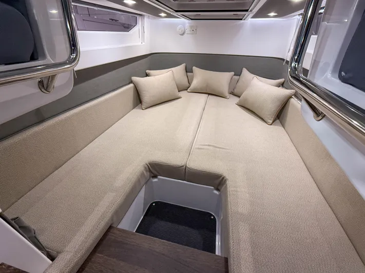 Tiny Dancer Yacht Photos Pics Luxurious interior cabin of 2020 Axopar 37 XC with beige cushions and modern design.