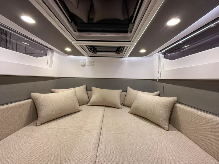 Tiny Dancer Yacht Photos Pics Luxurious cabin interior of 2020 Axopar 37 XC with plush cushions and ambient lighting.