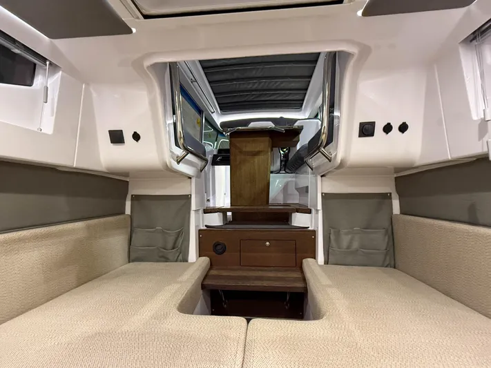 Tiny Dancer Yacht Photos Pics 2020 Axopar 37 XC cabin interior with beige seating and wooden accents.