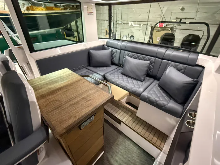 Tiny Dancer Yacht Photos Pics Luxurious interior of 2020 Axopar 37 XC with plush seating and wooden table.
