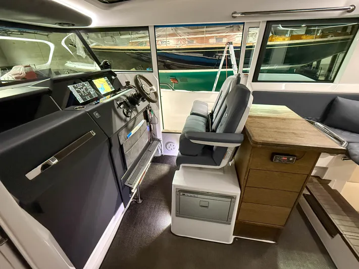 Tiny Dancer Yacht Photos Pics Interior of 2020 Axopar 37 XC boat with helm, seating, and navigation equipment.