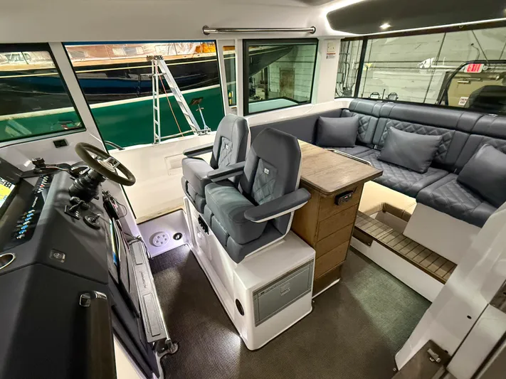 Tiny Dancer Yacht Photos Pics Interior of 2020 Axopar 37 XC boat with seating and helm station.