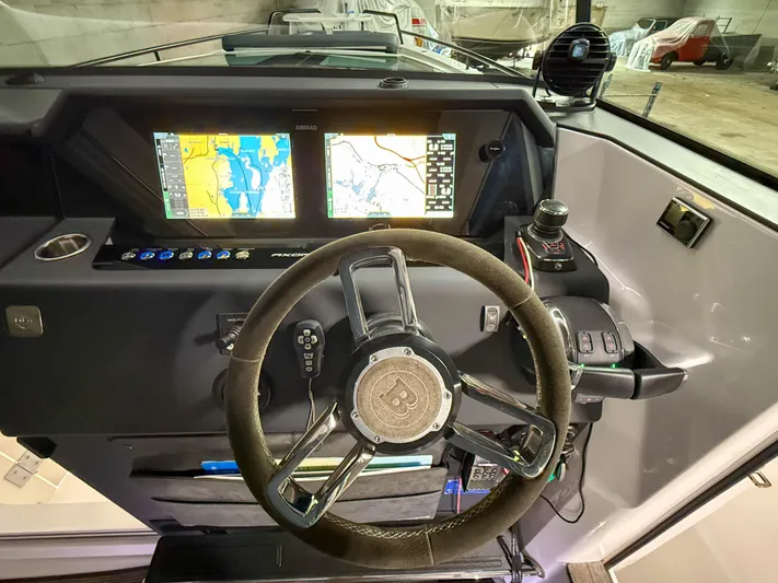 Tiny Dancer Yacht Photos Pics 2020 Axopar 37 XC dashboard with dual navigation screens and steering wheel.