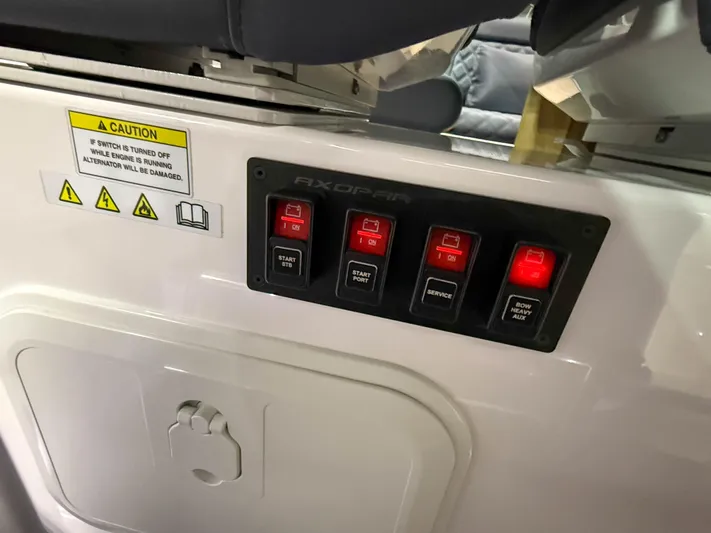 Tiny Dancer Yacht Photos Pics Control panel on a 2020 Axopar 37 XC boat with illuminated switches and caution label.
