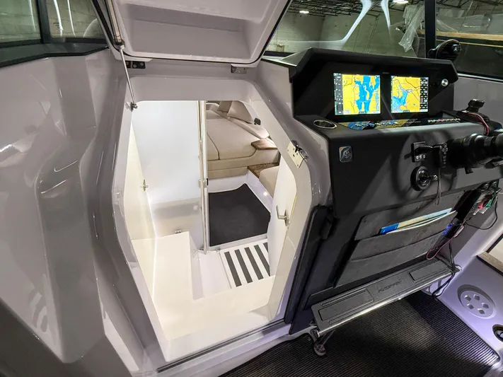 Tiny Dancer Yacht Photos Pics 2020 Axopar 37 XC cabin interior with navigation screens and seating area.