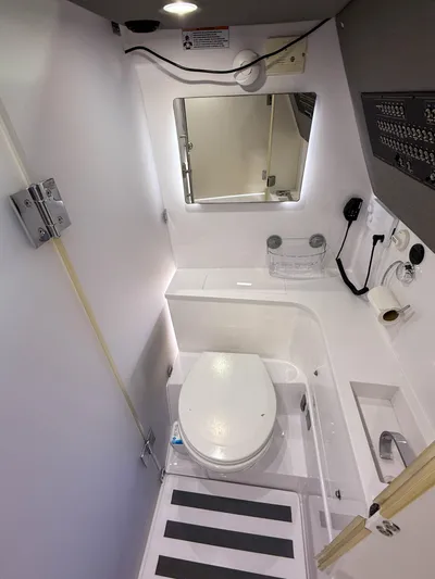 Tiny Dancer Yacht Photos Pics 2020 Axopar 37 XC boat bathroom with modern fixtures and compact design.