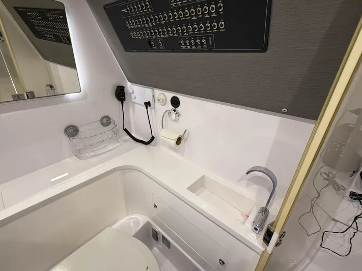Tiny Dancer Yacht Photos Pics 2020 Axopar 37 XC boat bathroom with modern fixtures and control panel.