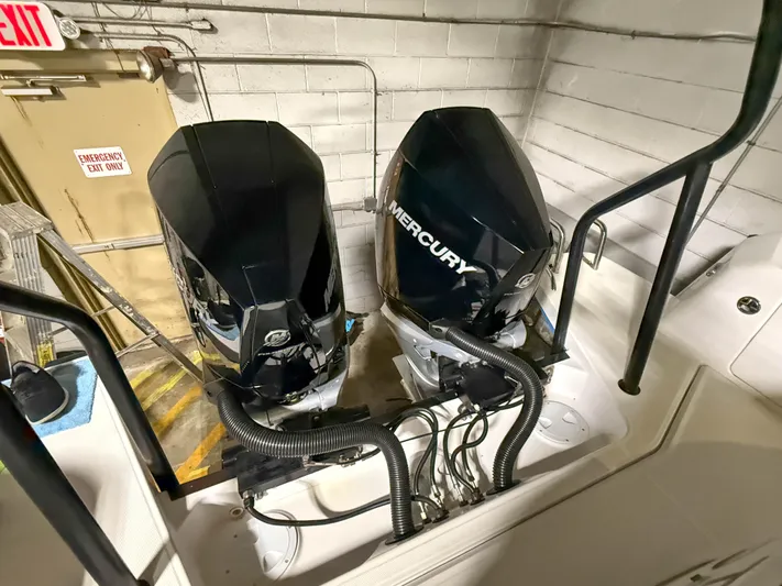 Tiny Dancer Yacht Photos Pics Twin Mercury outboard engines on a 2020 Axopar 37 XC boat in a garage setting.