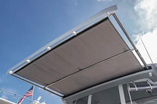 R&r 5 Yacht Photos Pics 2022 Intrepid 477 Evolution boat with extended sunshade against blue sky.