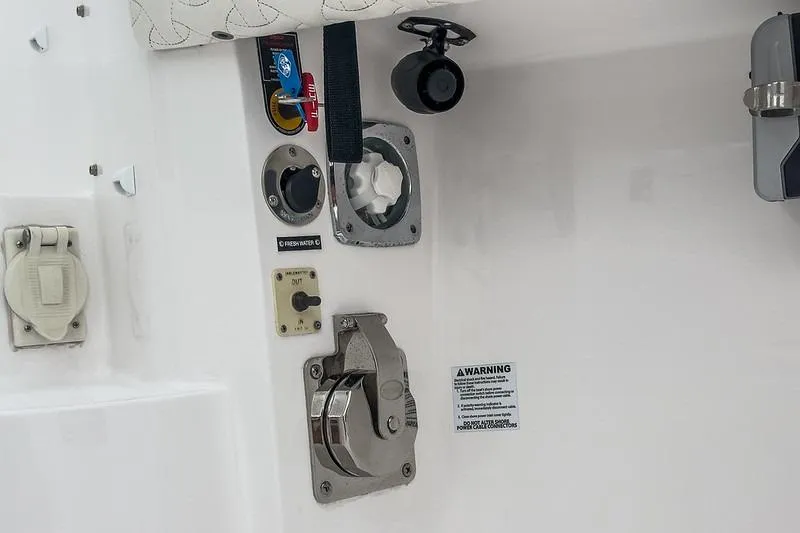 R&r 5 Yacht Photos Pics Control panel on 2022 Intrepid 477 Evolution boat, featuring various switches and warning label.