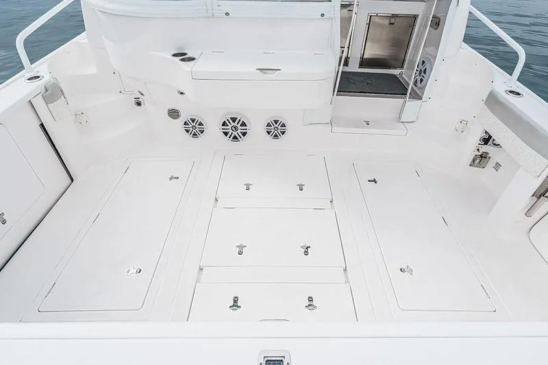 R&r 5 Yacht Photos Pics 2022 Intrepid 477 Evolution boat deck with storage compartments and speakers.