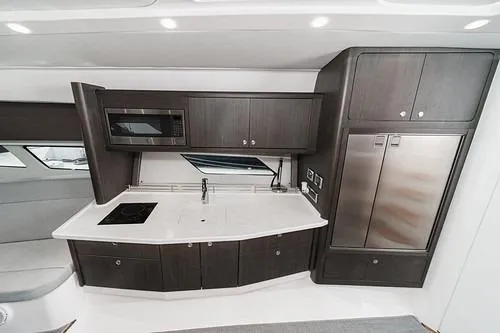R&r 5 Yacht Photos Pics 2022 Intrepid 477 Evolution yacht kitchen with modern appliances and sleek cabinetry.