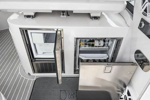 R&r 5 Yacht Photos Pics 2022 Intrepid 477 Evolution yacht interior with open refrigerator and storage compartments.