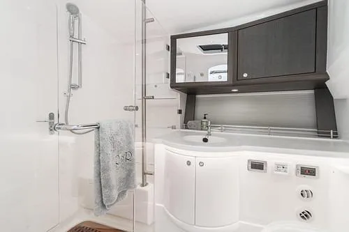 R&r 5 Yacht Photos Pics Luxurious bathroom in 2022 Intrepid 477 Evolution yacht with modern fixtures and sleek design.