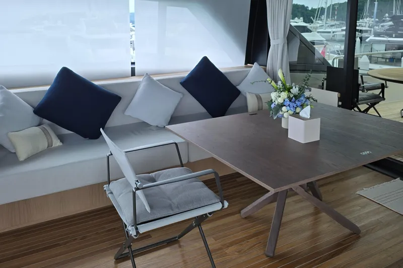  Yacht Photos Pics Luxurious interior of 2024 Sanlorenzo SX100 yacht with elegant seating and table arrangement.