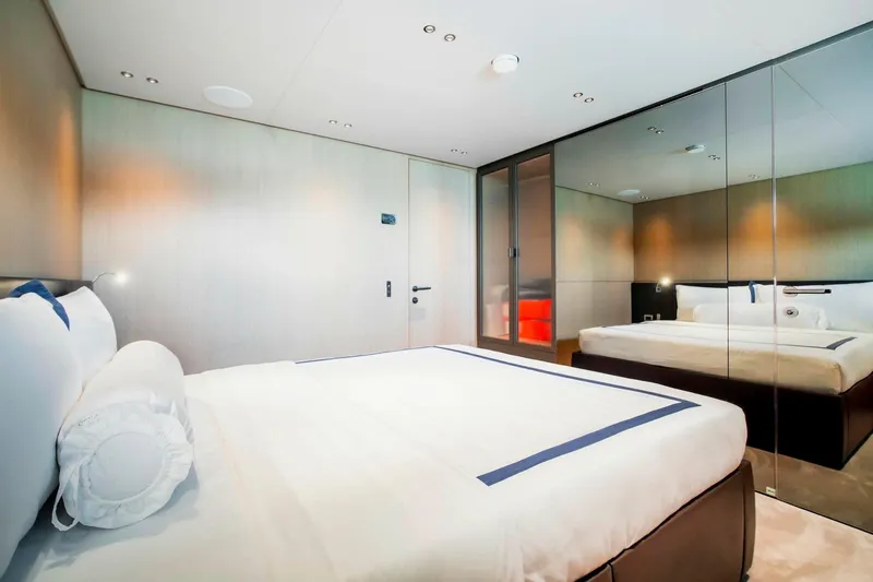  Yacht Photos Pics Luxurious bedroom interior of 2024 Sanlorenzo SX100 yacht with modern design and mirrored walls.