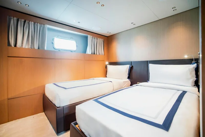  Yacht Photos Pics Luxurious twin bedroom on 2024 Sanlorenzo SX100 yacht, featuring modern design and cozy ambiance.