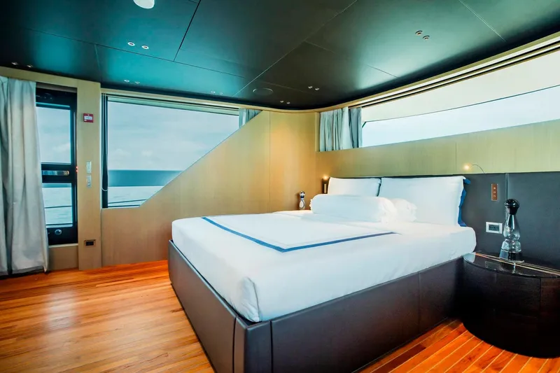  Yacht Photos Pics Luxurious bedroom interior of 2024 Sanlorenzo SX100 yacht with ocean view.